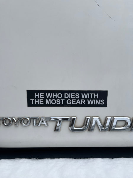 He Who Dies With The Most Gear Wins Bumper Sticker